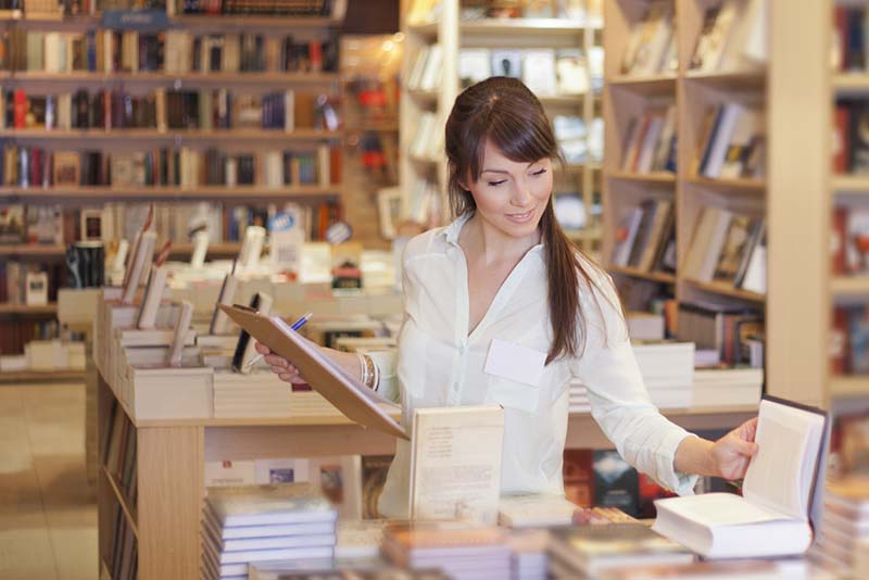 A bookstore owner consider general liability insurance while she works.