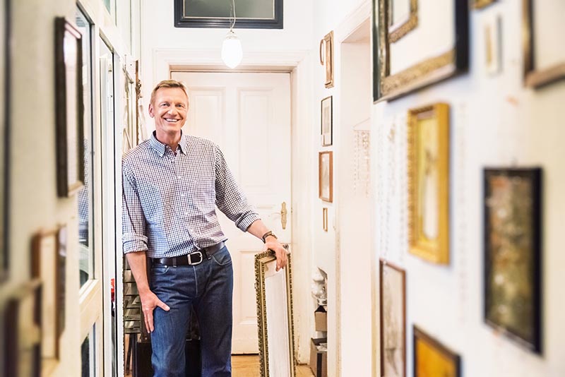 A man shows off his insured fine art collection