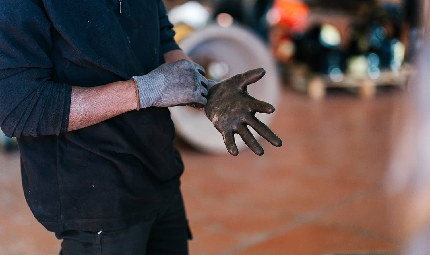 A mechanic puts on gloves.