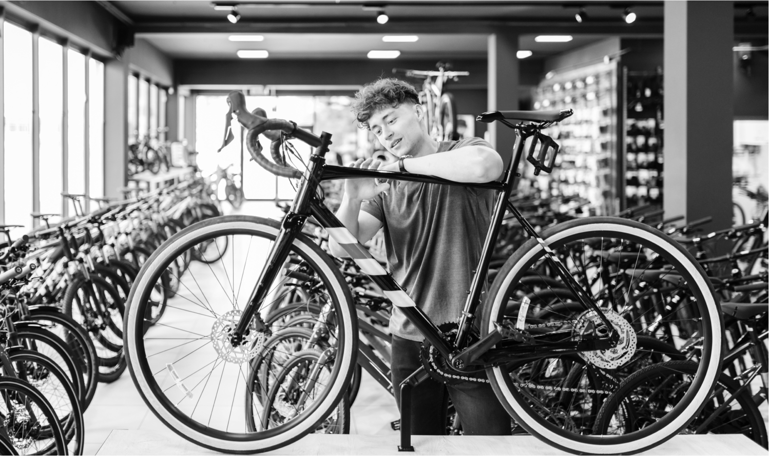 A technician works on a bicycle in a bike shop.